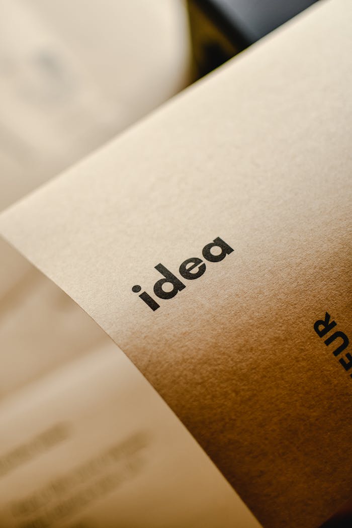 about-us-02 Close-up shot of the word 'idea' printed on brown paper, perfect for representing creativity and startups.